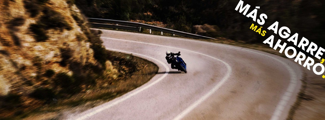 BMW S 1000 XR riding on Dunlop Mutant tyres with mountains in the background