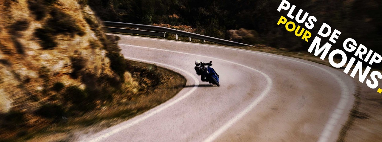 BMW S 1000 XR riding on Dunlop Mutant tyres with mountains in the background