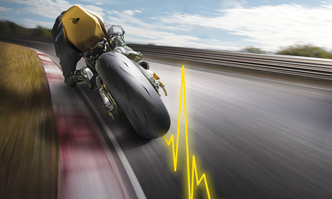 Dunlop GP Racer D212 hyperport tyre in use on a race track with yellow pulse line
