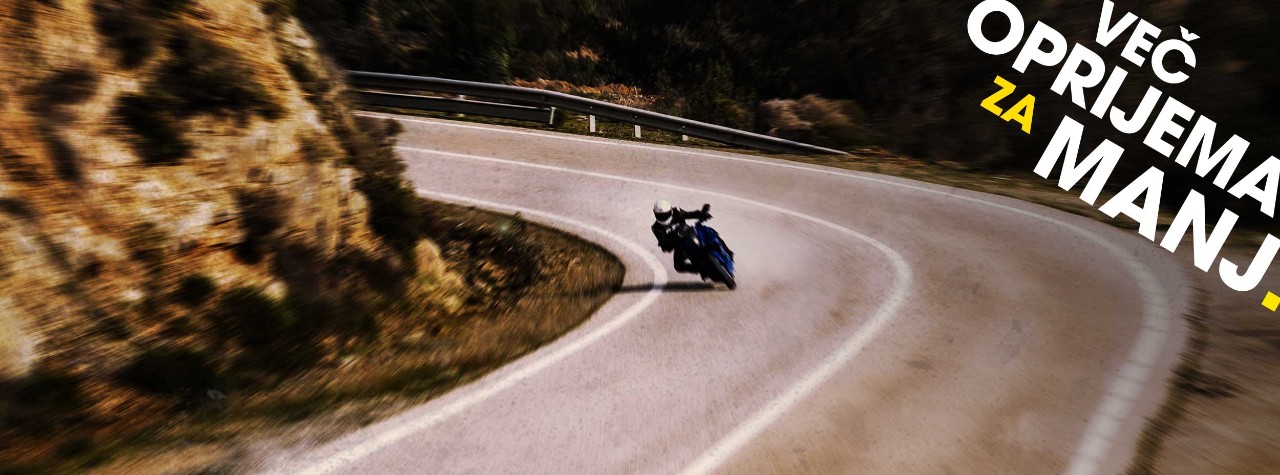BMW S 1000 XR riding on Dunlop Mutant tyres with mountains in the background
